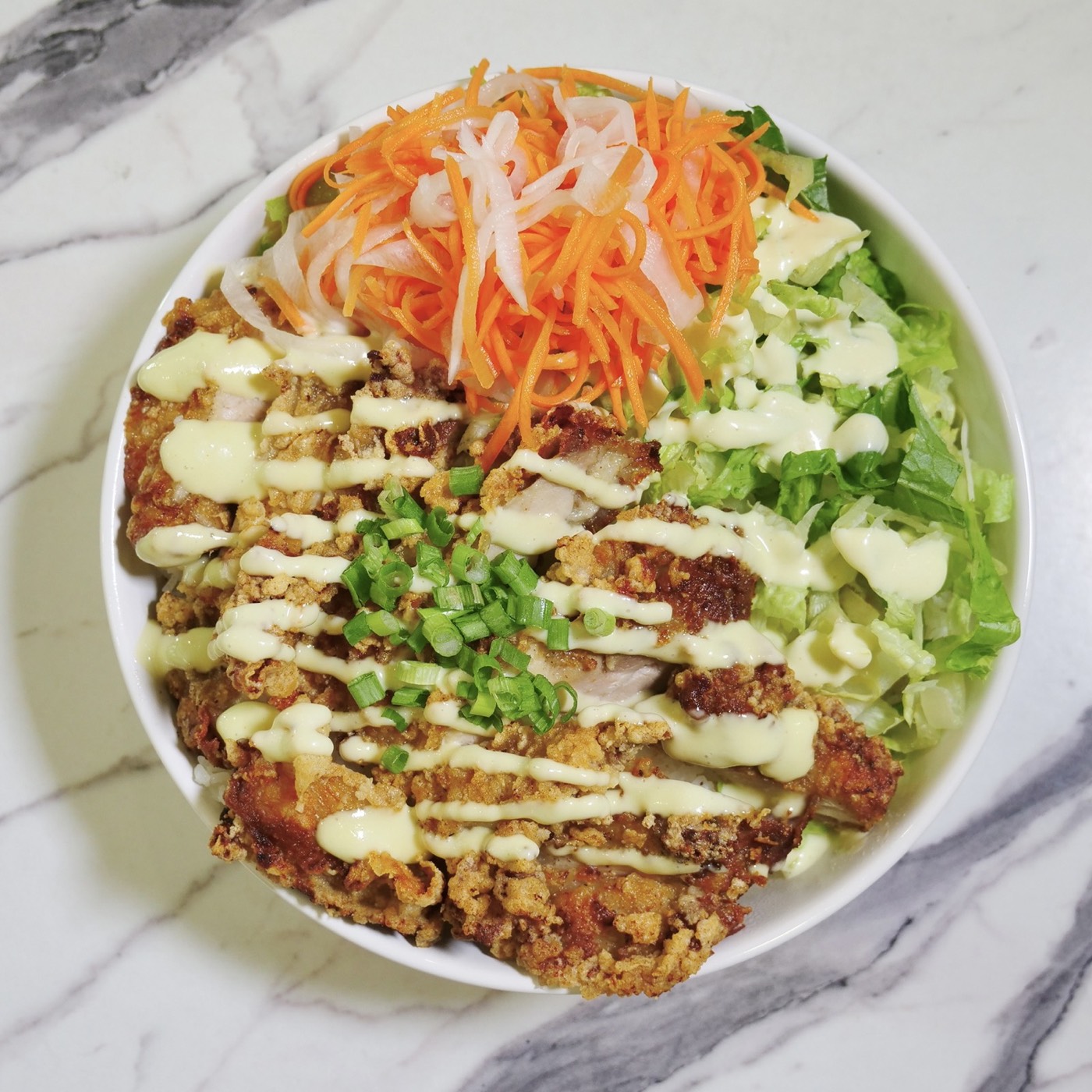 Crispy Chicken rice bowl with ginger scallion aioli and pickled carrot and daikon